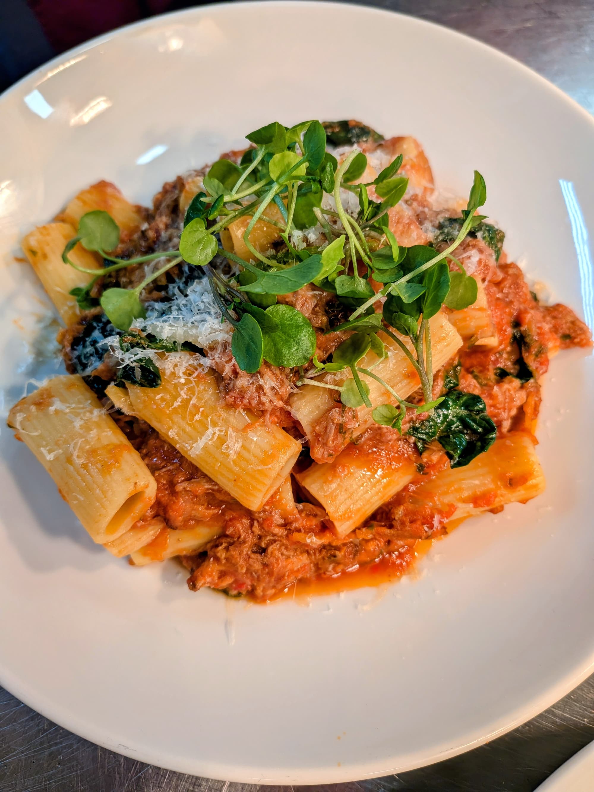 Pasta bolognese dish finished with parmesan